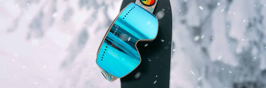 blue and black surfboard on snow covered ground